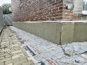 Цоколь дома утеплён, выполнен монтаж уголков, дюбелирование. Ведутся армировочные работы 